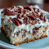 Slice of moist Mexican-American Butter Pecan Tres Leches Cake revealing tender crumb and a creamy, nutty topping on a rustic plate.