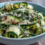 Fresh shaved zucchini ribbon salad with tangy lemon dressing and nutty Parmesan cheese.