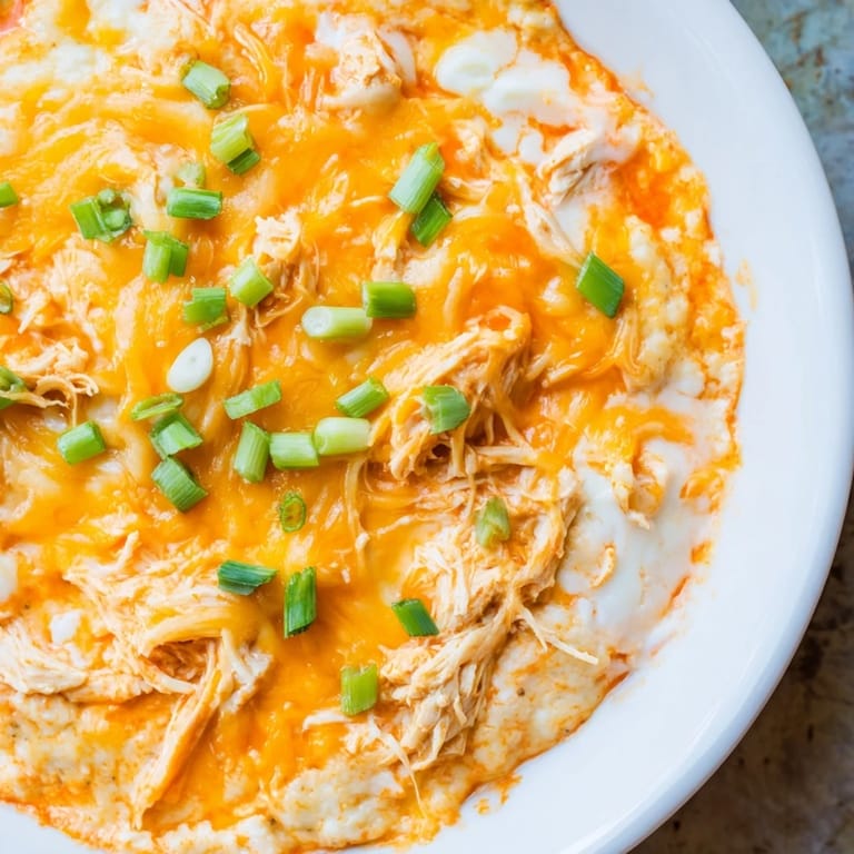 Melted cheese coats a savory Buffalo Chicken Dip, perfect party appetizer with shredded chicken.