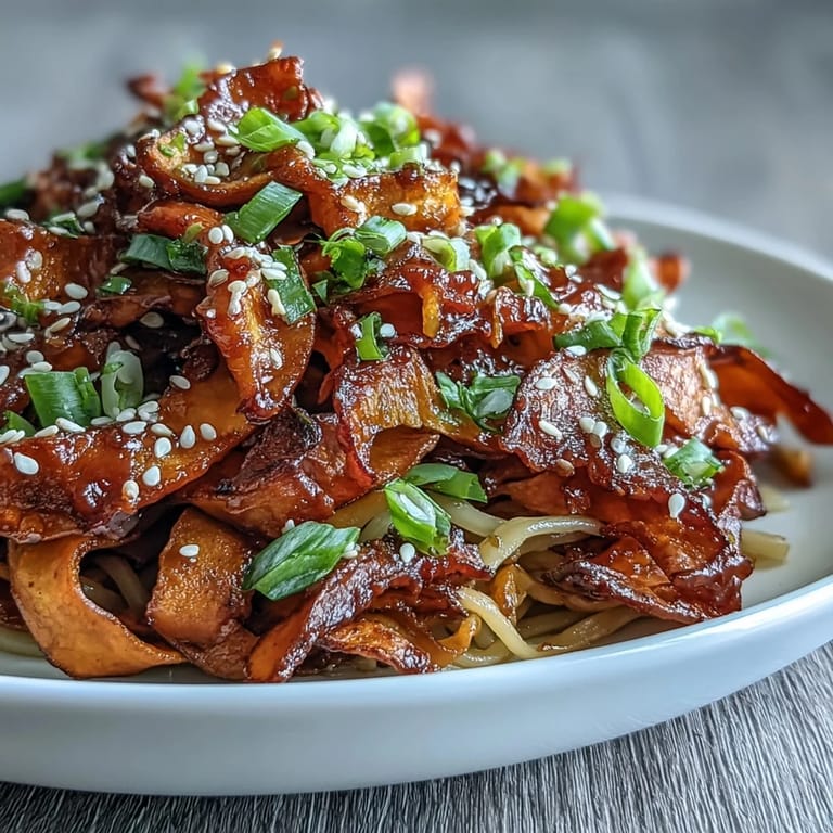 Golden roasted swede ribbons tossed with rice noodles, fresh scallions, and sesame seeds in a glossy gochujang glaze.
